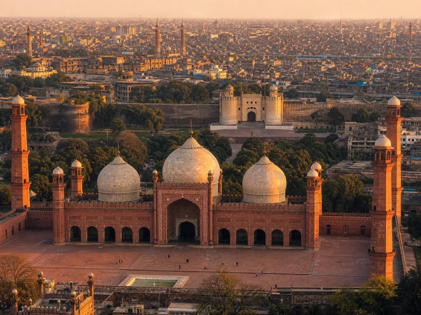 Badshahi Mosque and Lahore Fort rising above the historic Walled City at golden hour