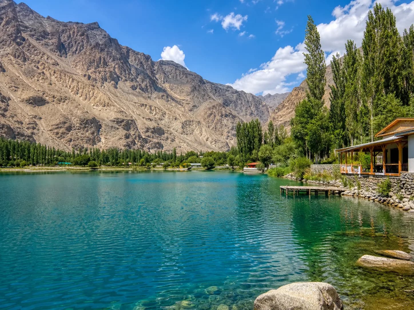 Upper Kachura Lake surrounded by poplars and the dry mountains of Skardu